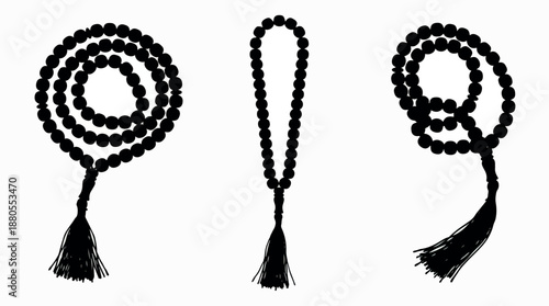 Set of three black prayer beads with tassels for spiritual meditation.