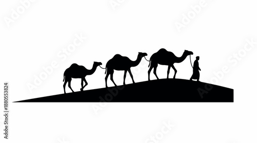 Silhouette of a man leading three camels across a desert dune.