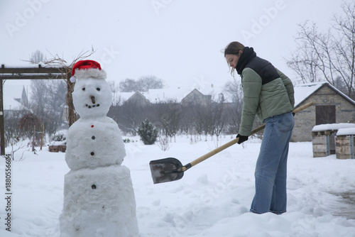 Wallpaper Mural Young woman shoveling snow. Winter lifestyle. Removing snow after blizzard. Torontodigital.ca