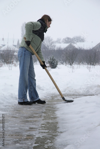 Wallpaper Mural Young woman shoveling snow. Winter lifestyle. Removing snow after blizzard. Torontodigital.ca
