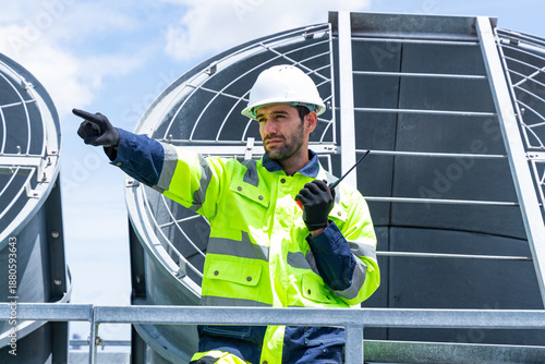 Quadro su tela Technicians discussing HVAC system on rooftop