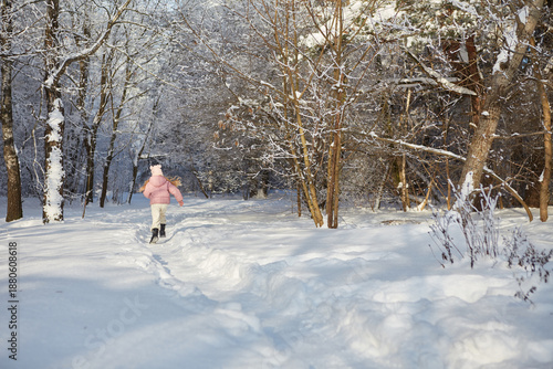young woman walking in winter forest