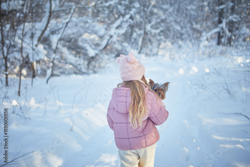 girl with yorkshire terrier in winter 