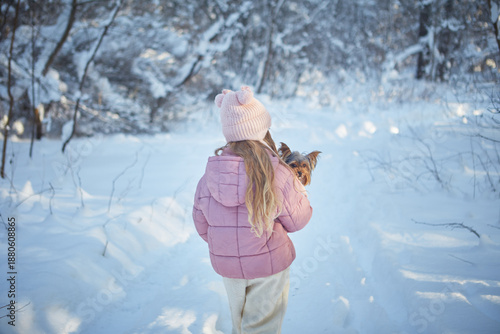 girl with yorkshire terrier in winter 