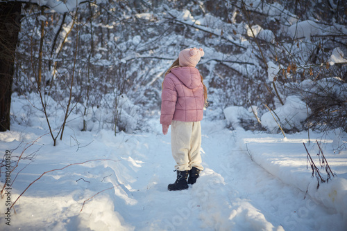 young woman walking in winter forest