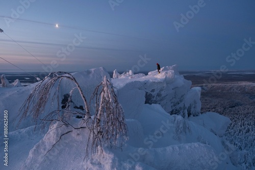 girl meets the dawn in the mountains of the Urals winter