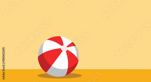 Colorful red and white striped beach ball rests on a yellow surface under a bright sky, evoking summer memories.