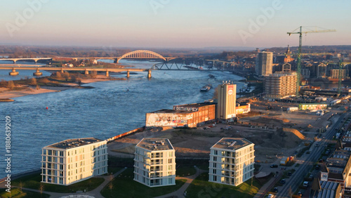 Modern Architecture in Nijmegen: Drone Shot of the New City Bridge De Oversteek Against Blue Sky
