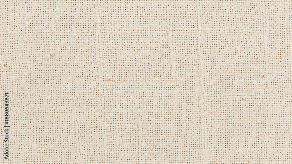 Fototapeta premium Close-up macro shot of a textured beige fabric with a subtle woven pattern and visible threads