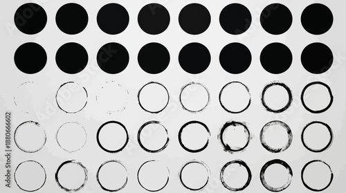 Abstract grid of black filled circles and hollow rings arranged in rows on white background