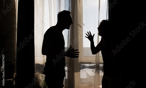 Photos Silhouetted Dispute: Couple in Conflict During a Home Quarrel.