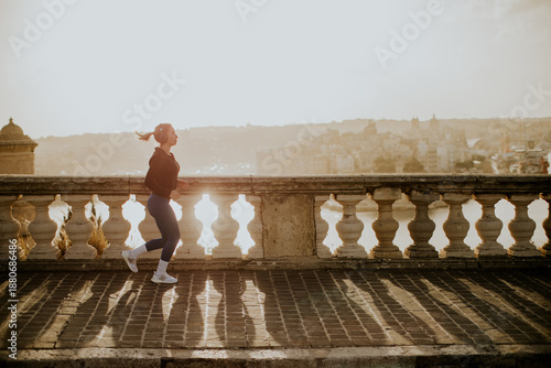 Woman running along the wat...