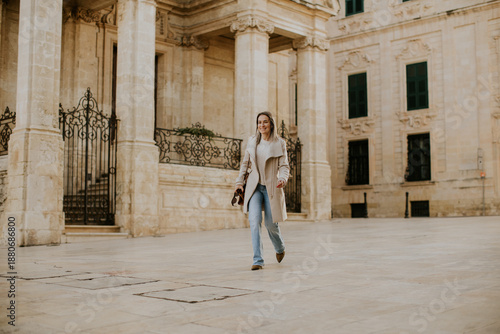 Woman walks in historic str...