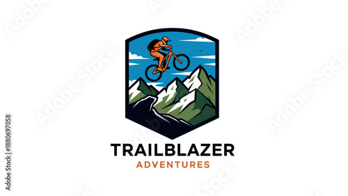 A vibrant logo for Trailblazer Adventures featuring a mountain biker jumping over a winding trail with green mountains and a blue sky in the background, all enclosed within a shield emblem.