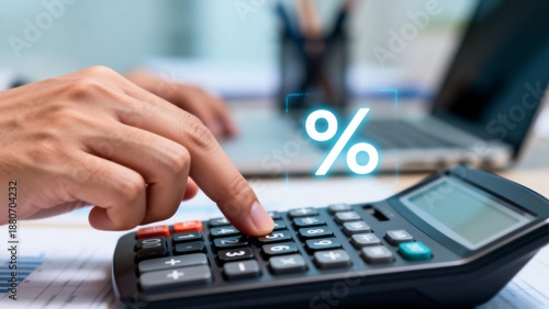 Hand using calculator with percentage symbol