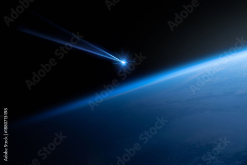 Comet, asteroid, meteorite flying to the planet Earth.  Glowing asteroid and tail of a falling comet threatening the safety of the Earth.  Elements of this image furnished by NASA.