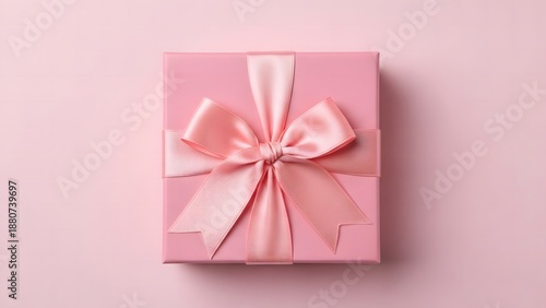 Elegant pink gift box with silk ribbon on pastel background, realistic shadow, mockup style, product photography.