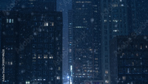 Snow Falls in the City at Night With Tall Buildings and Glowing Windows