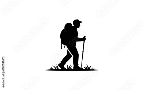A dark silhouette of a hiker with a backpack and walking stick