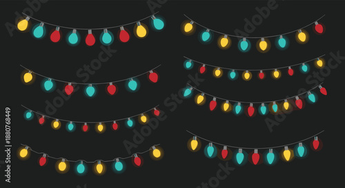 Strings of glowing colorful christmas lights in red, yellow, and teal draped across a dark gray background for festive holiday decoration.
