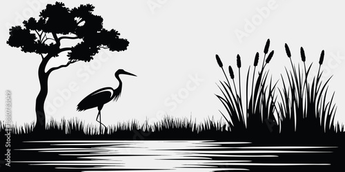 Silhouette of a wading bird tree and reeds reflected in water