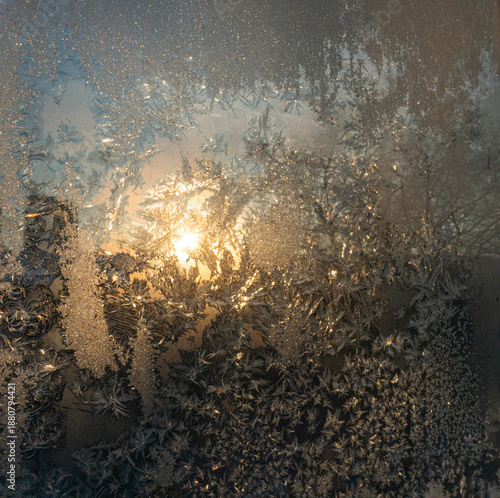 The view of the winter sun through frost patterns on the glass