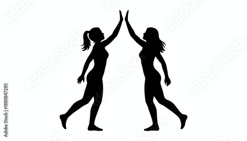 Two silhouetted women giving each other a high five in celebration.