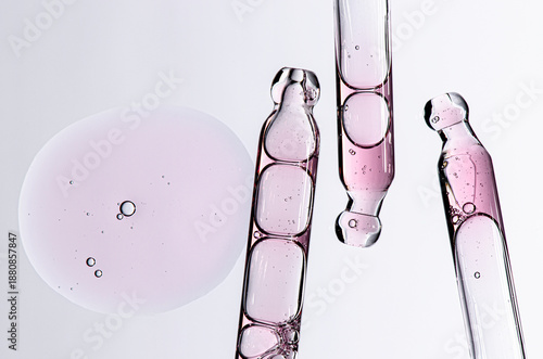 Skin serum in a pipette. A cosmetic product for body care. White background.