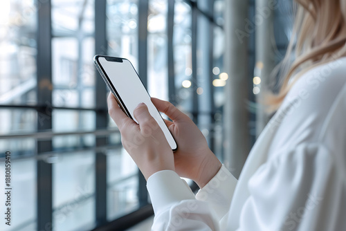 Hands holding smartphone with blank screen, clean modern lifestyle mockup