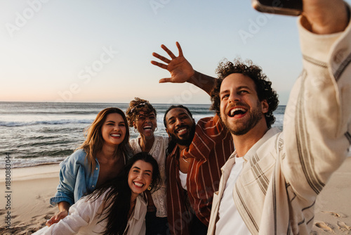 Konstfotografi Group of friends taking a selfie at a beach during sunset