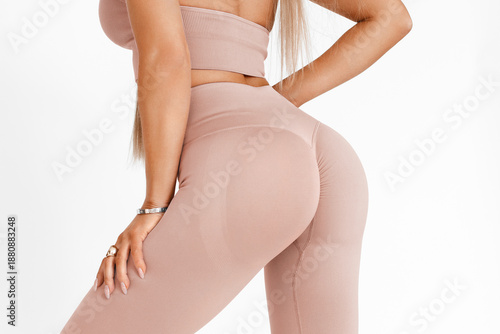 Fitness woman in leggings with beautiful buttocks. Sporty booty