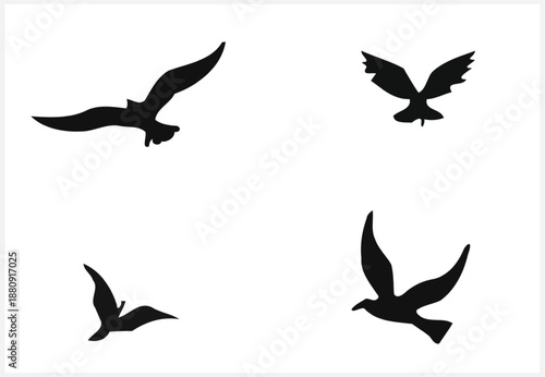 Four black silhouettes of birds in flight on white background
