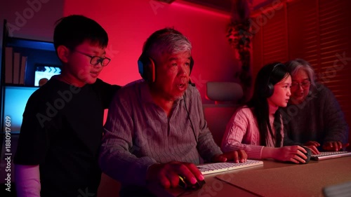 Win winner, Happy Emotional family playing games on computer at home. Asian Grandfather and grand daughter playing video games. enjoying time together indoors, Family leisure activity with children