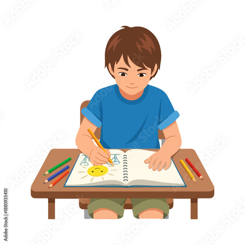 Young boy sitting at desk drawing sun in notebook using colored pencils