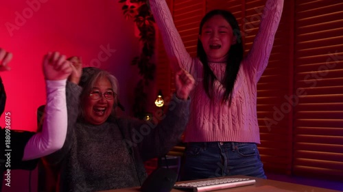 Win winner, Happy Emotional family playing games on computer at home. Asian Grandfather and grand daughter playing video games. enjoying time together indoors, Family leisure activity with children