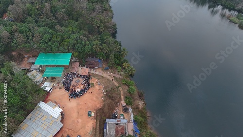 Wallpaper Mural Unique drone shot combining a scenic backwater road, lush coconut greenery, and a traditional temple gathering in North Malabar. Torontodigital.ca
