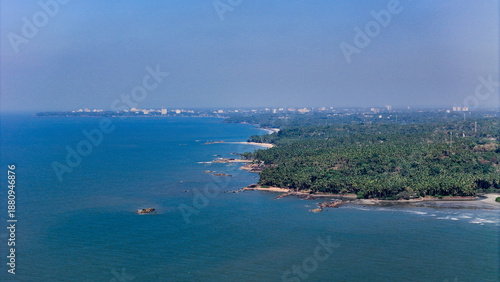 Wallpaper Mural Breathtaking aerial view of the Kerala shoreline, showcasing a dense forest of coconut trees bordering the waves of the Indian Ocean and kannur city Torontodigital.ca