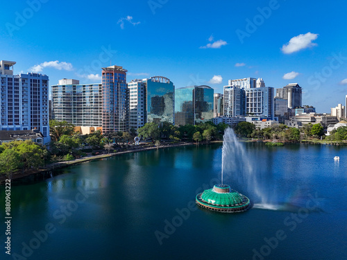 Fountain at Lake Eola with high-rises in background at downtown Orlando in Orange County, Florida.