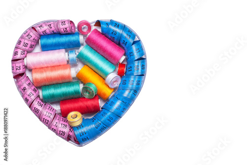 Sewing kit, bobbins with colored threads and a measuring tape.