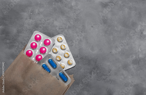 Paper bag with yellow and blue medical pills.