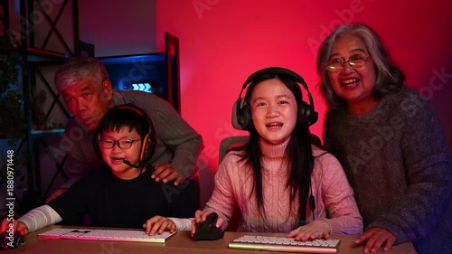 Win winner, Happy Emotional family playing games on computer at home. Asian Grandfather and grand daughter playing video games. enjoying time together indoors, Family leisure activity with children