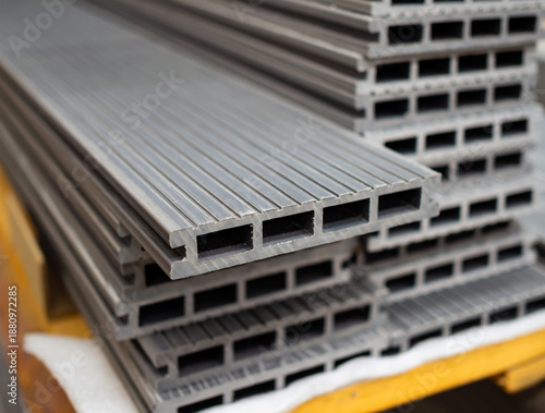 Modern polymer decking boards stacked. (Shallow depth of field)