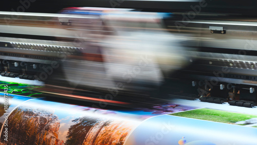 Tablou pe pânză Industrial multi-color printing on paper using a modern digital inkjet RGB printer; the print head blurs as it moves