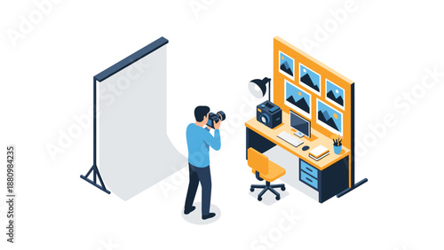 Photographer in studio with computer setup and camera equipment