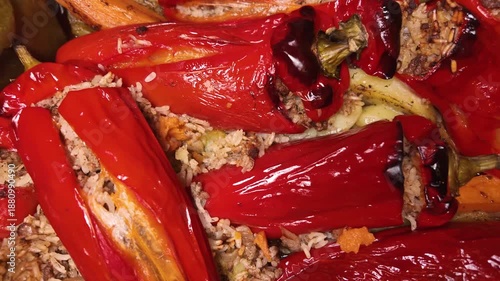 The classic greek dish, Gemista, a vibrant plate of red and green peppers, potatoes, sweet patatoes, stuffed with rice, herbs, and minced meat, baked and drizzled  with olive oil, classic greek food