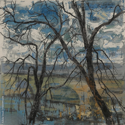 Bare trees stand against a vibrant blue and white cloudy sky