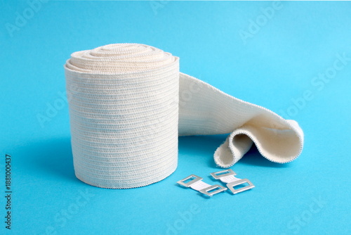Canvastavla There is a roll of elastic bandage on a blue background.