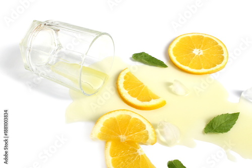 Bilde på lerret There is spilled orange juice with ice on a white background.
