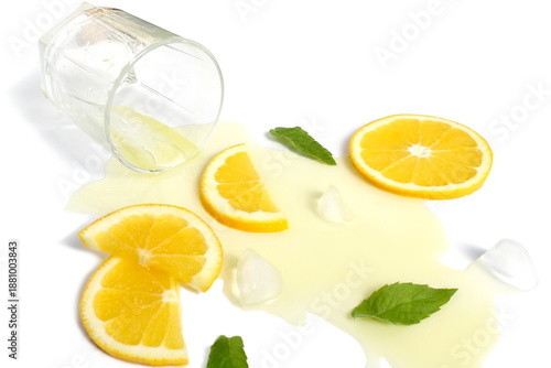 Bilde på lerret There is spilled orange juice with ice on a white background.