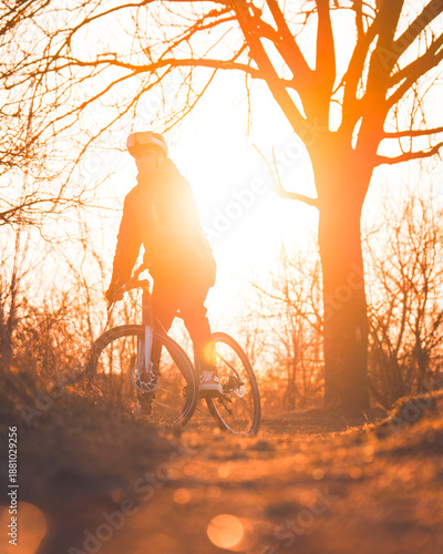 Cyclist riding a bike at sunset
